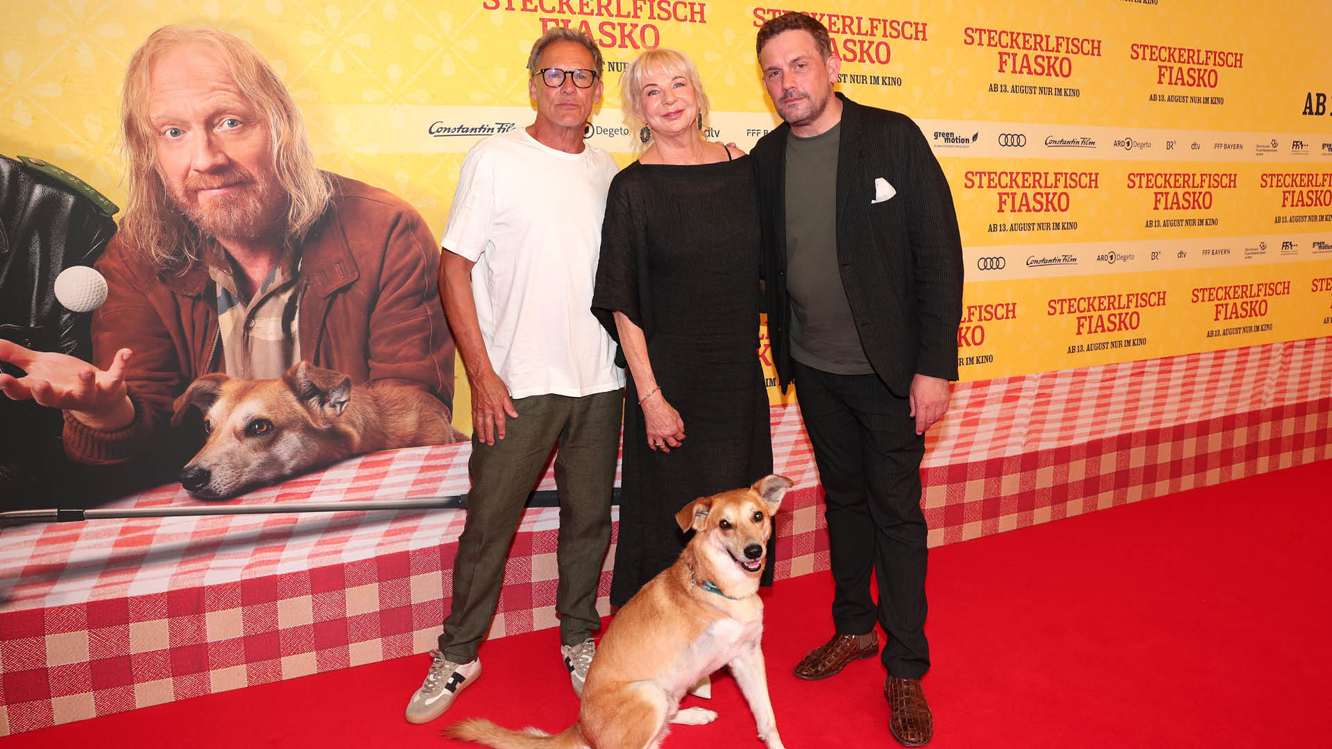 Christian Tramitz, Rita Falk (Author), dog Noah ((Hinkelotta)) and Sebastian Bezzel attend the world premiere of "Steckerlfischfiasko" at Mathäser Filmpalast on August 10, 2026 in Munich, Germany.